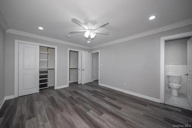 wooden floor in an empty room with a bathroom