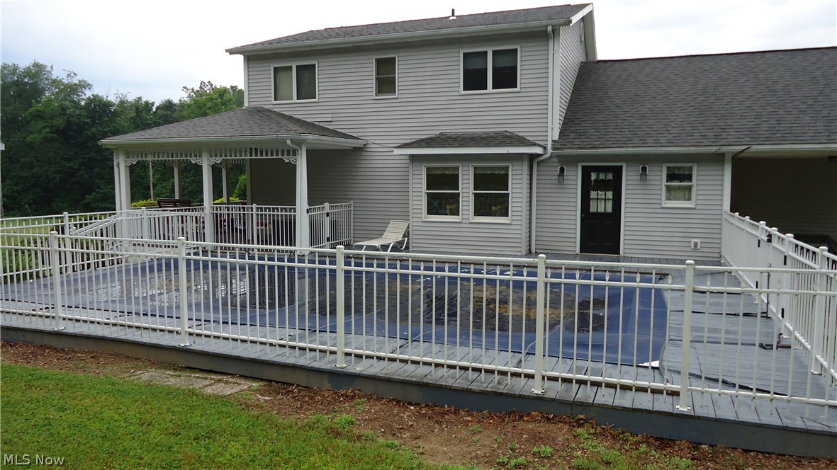 11720 Walker Road Minerva, OH 44657 - Photo 21 of 21 rear view, above ground pool surrounded by deck and fence, equipment remains with property