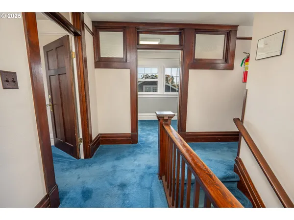 a view of entryway with a window and wooden floor