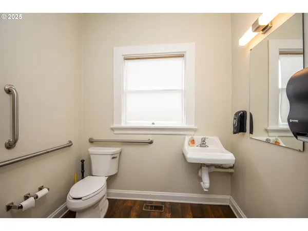 a bathroom with a sink toilet and a mirror