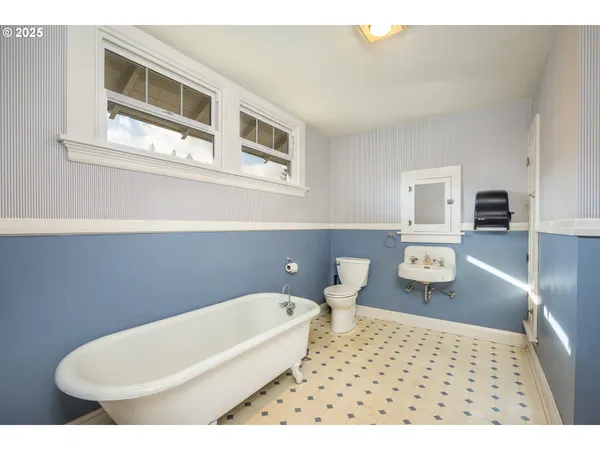 a bathroom with a toilet a sink and bathtub