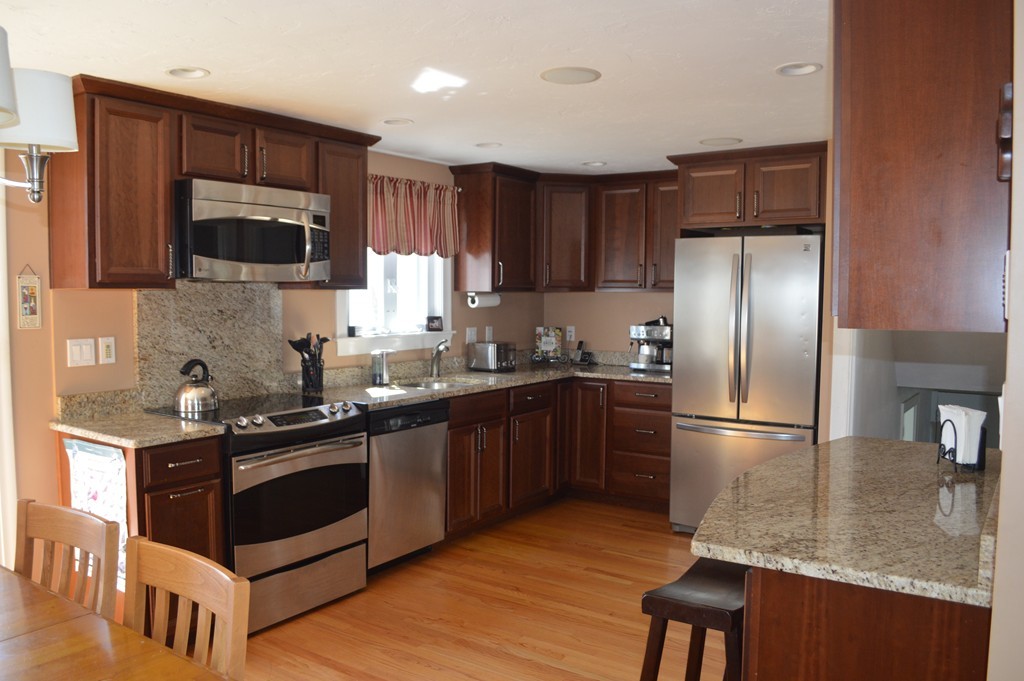 39 Miriam Road Waltham, MA 02451 - Photo 2 of 20 a kitchen with stainless steel appliances granite countertop a stove a sink dishwasher a refrigerator and a microwave