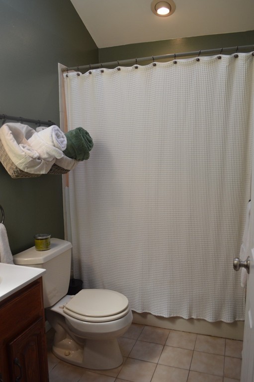 39 Miriam Road Waltham, MA 02451 - Photo 8 of 20 a white toilet sitting next to a shower curtain