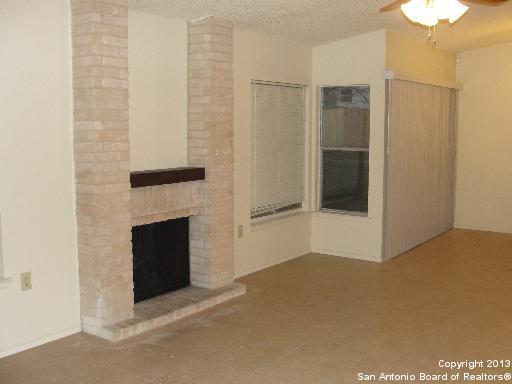 16307 Bitter Creek Street San Antonio, TX 78247 - Photo 2 of 12 a view of an empty room with a fireplace