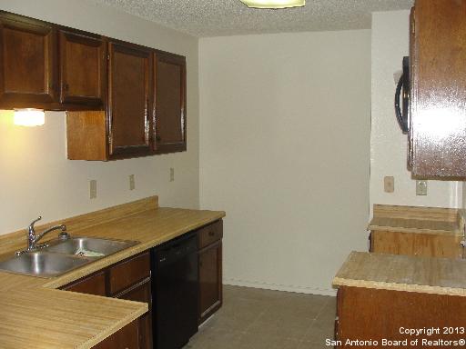 16307 Bitter Creek Street San Antonio, TX 78247 - Photo 4 of 12 a kitchen with a sink cabinets and a wooden floor