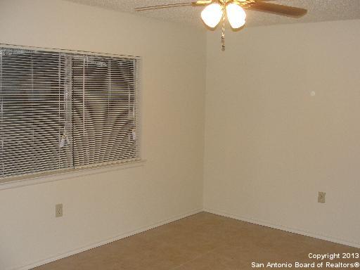 16307 Bitter Creek Street San Antonio, TX 78247 - Photo 5 of 12 a view of a small space with wooden floor a chandelier fan and windows