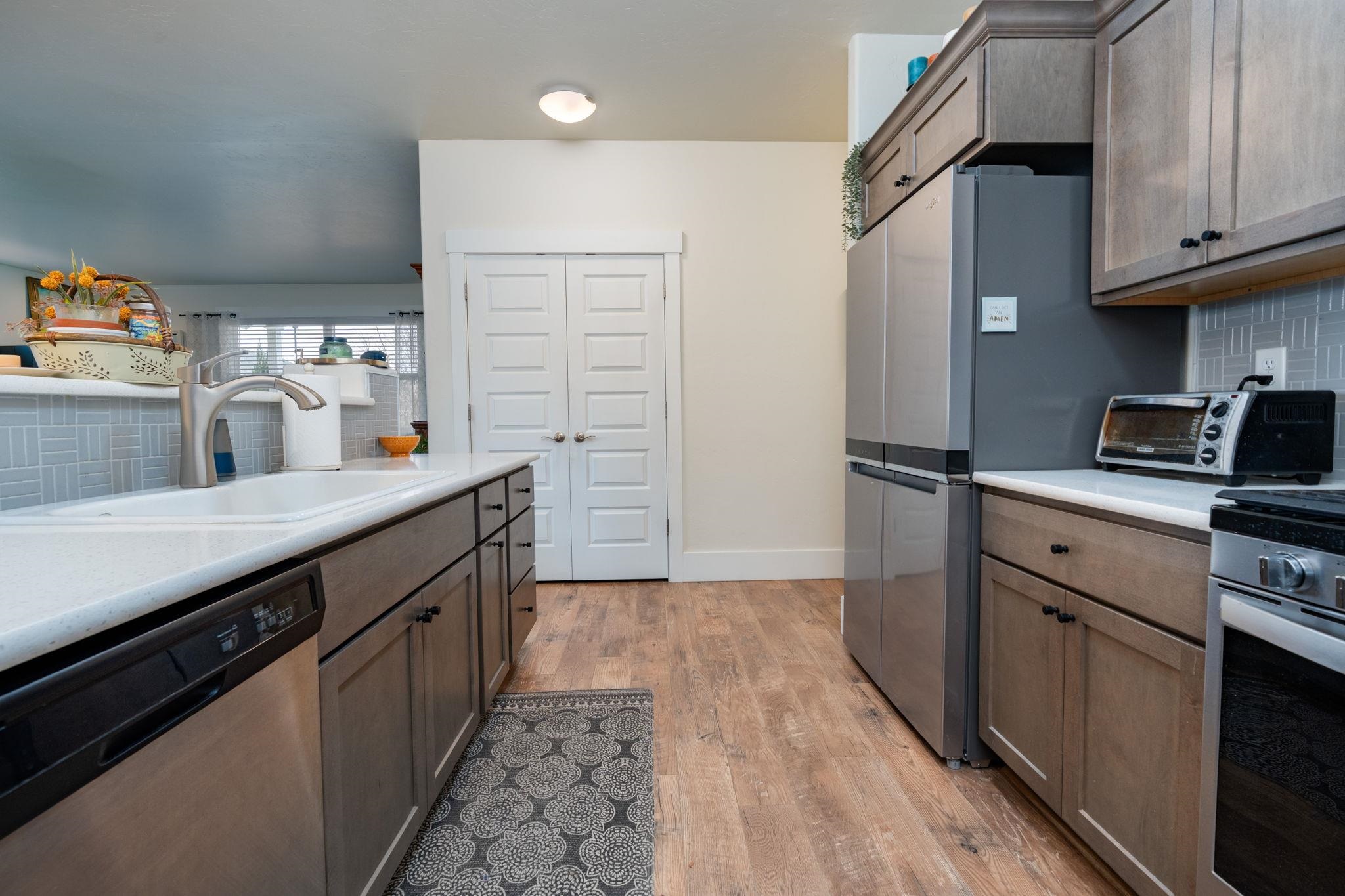 1222 Periwinkle Lane Fruita, CO 81521 - Photo 11 of 27 a kitchen with stainless steel appliances a sink stove and refrigerator
