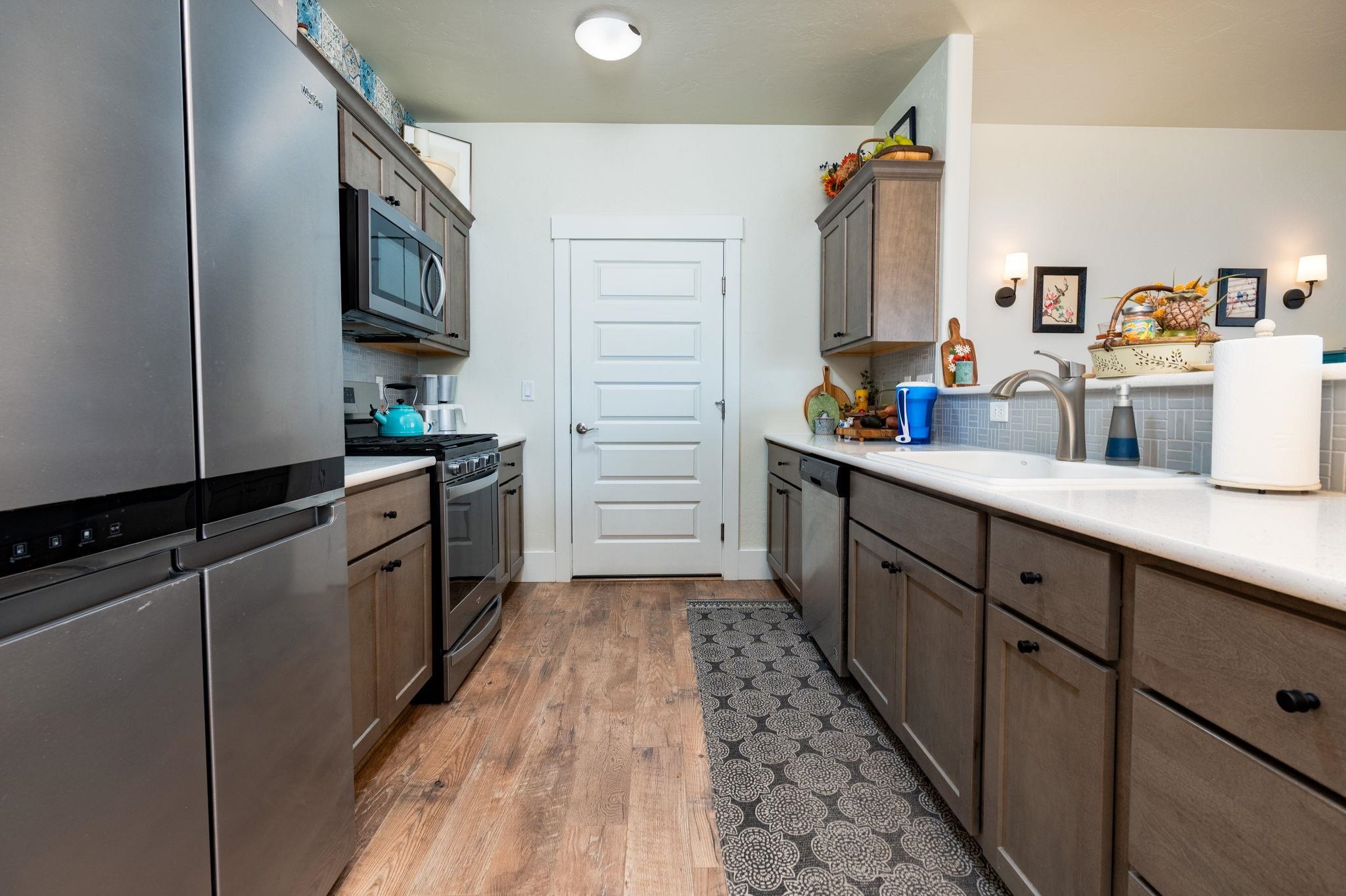 1222 Periwinkle Lane Fruita, CO 81521 - Photo 12 of 27 a kitchen with stainless steel appliances a sink stove and cabinets