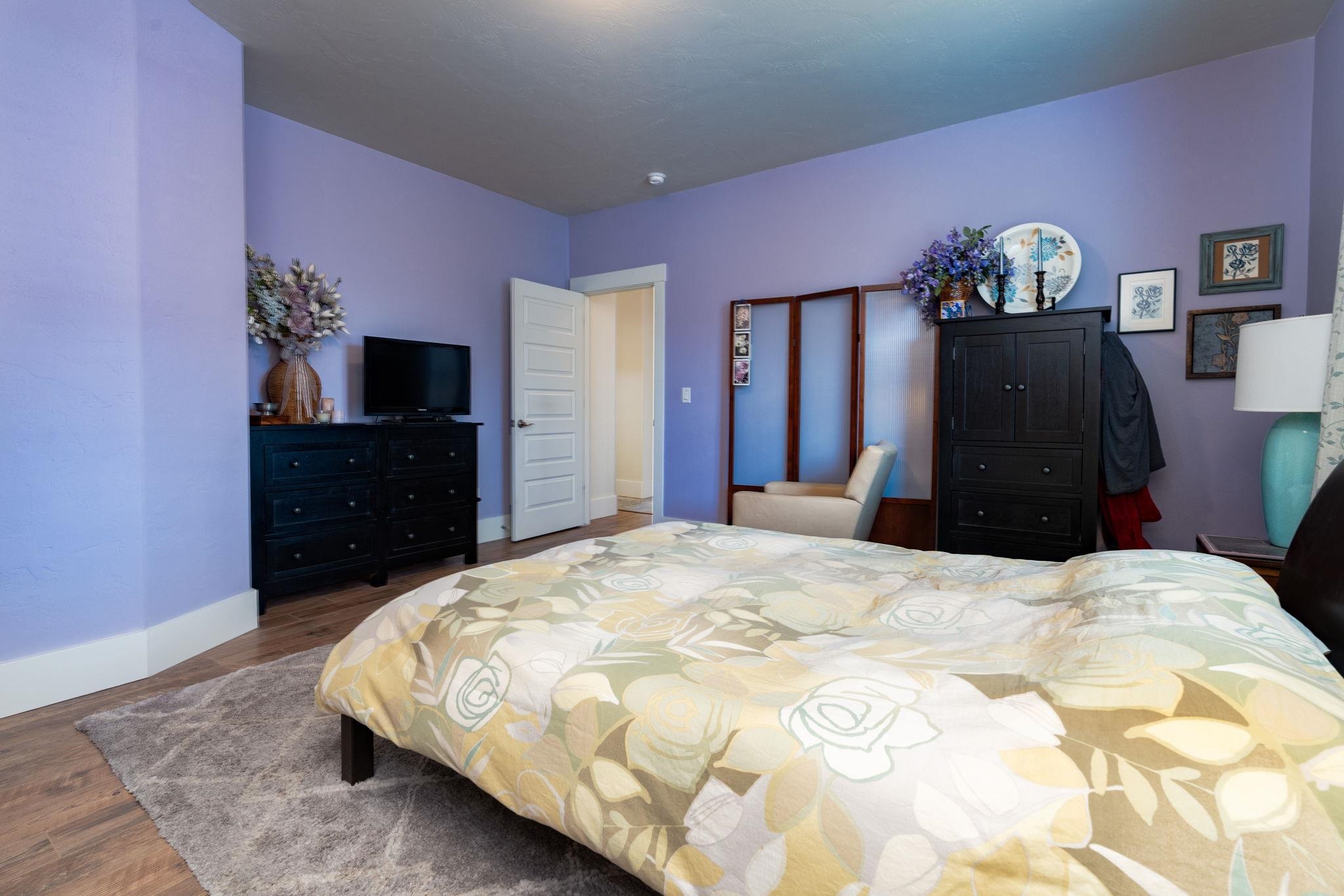 1222 Periwinkle Lane Fruita, CO 81521 - Photo 16 of 27 a bedroom with a bed and a dresser