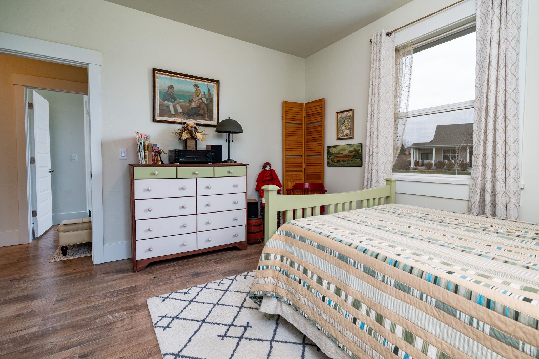 1222 Periwinkle Lane Fruita, CO 81521 - Photo 20 of 27 a bedroom with a bed and a dresser