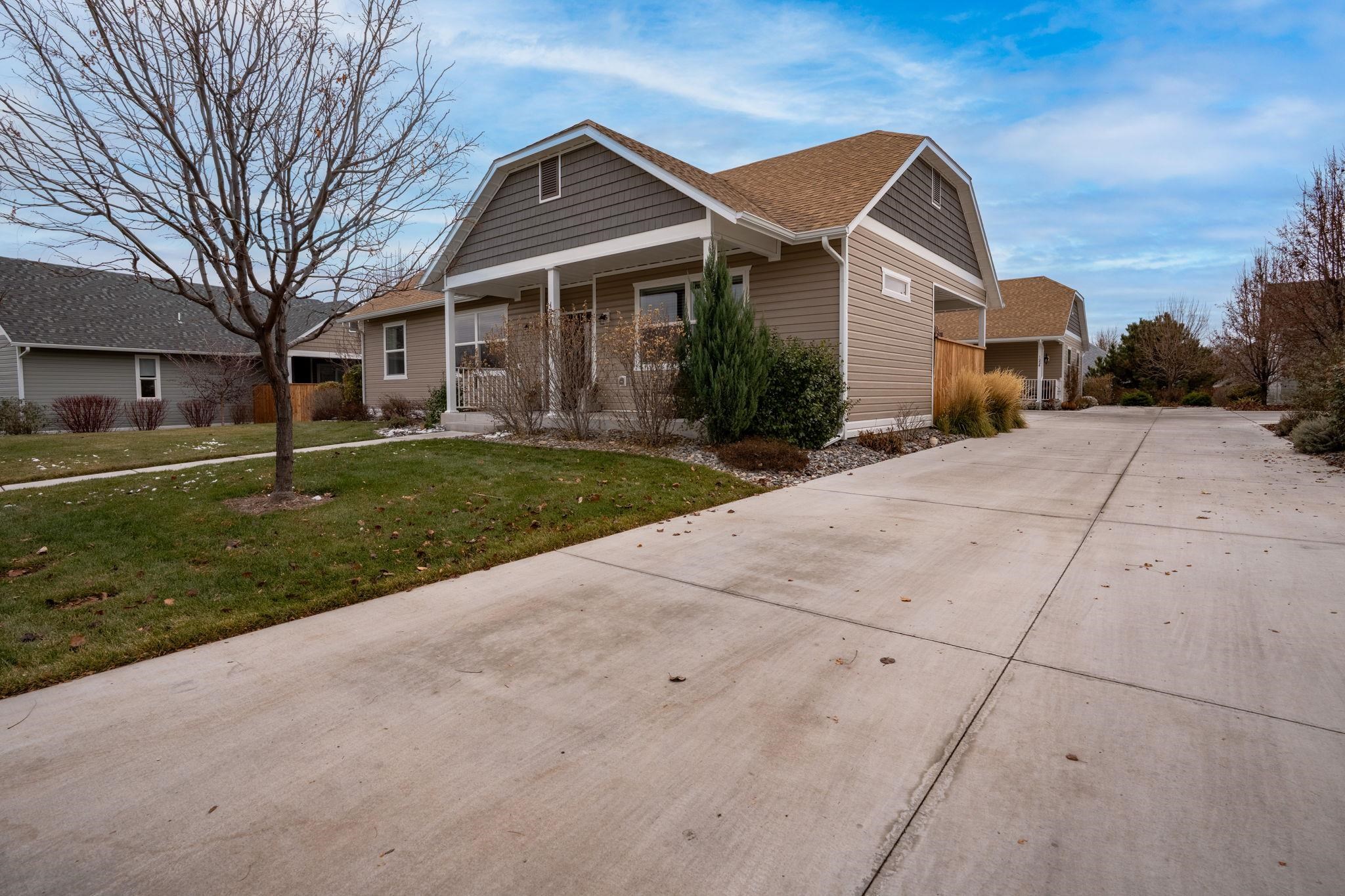 1222 Periwinkle Lane Fruita, CO 81521 - Photo 2 of 27 a front view of a house with a yard