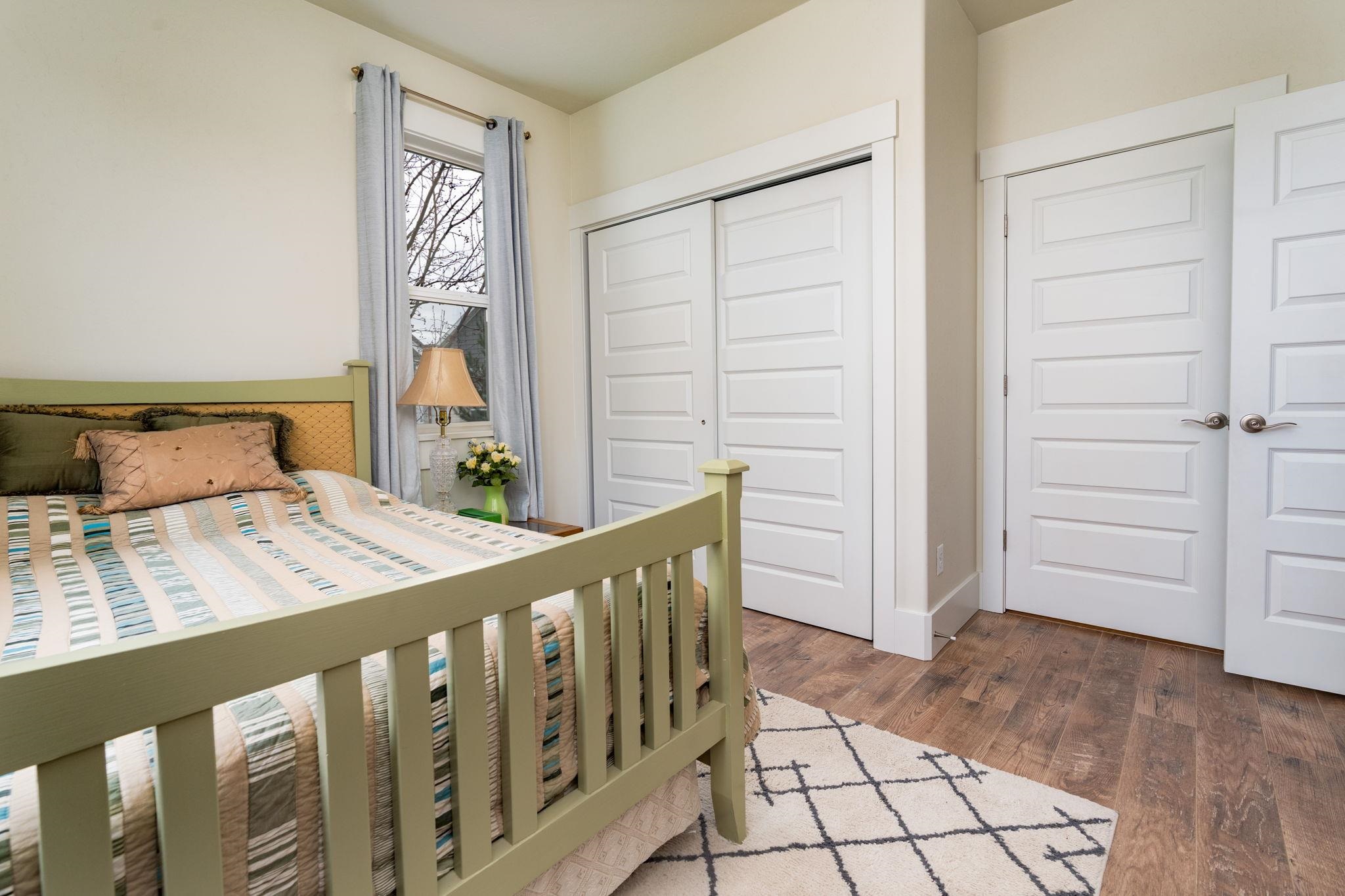 1222 Periwinkle Lane Fruita, CO 81521 - Photo 21 of 27 a bedroom with a bed and a window