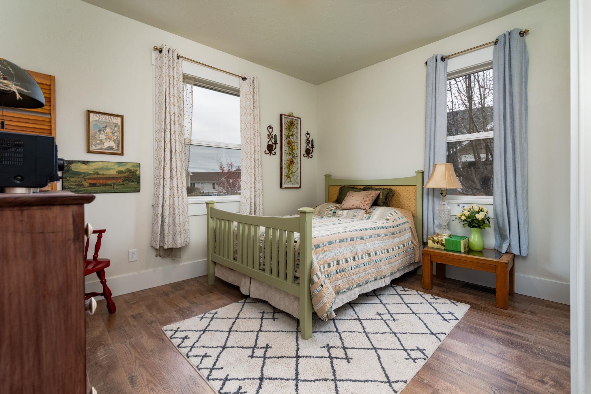 1222 Periwinkle Lane Fruita, CO 81521 - Photo 22 of 27 a bedroom with furniture and a window
