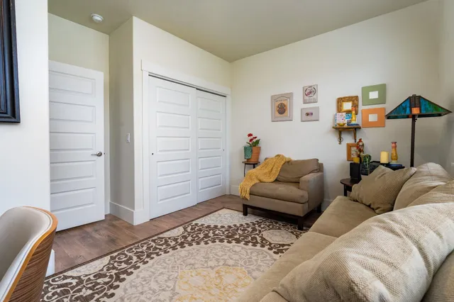 a living room with furniture a couch and a window