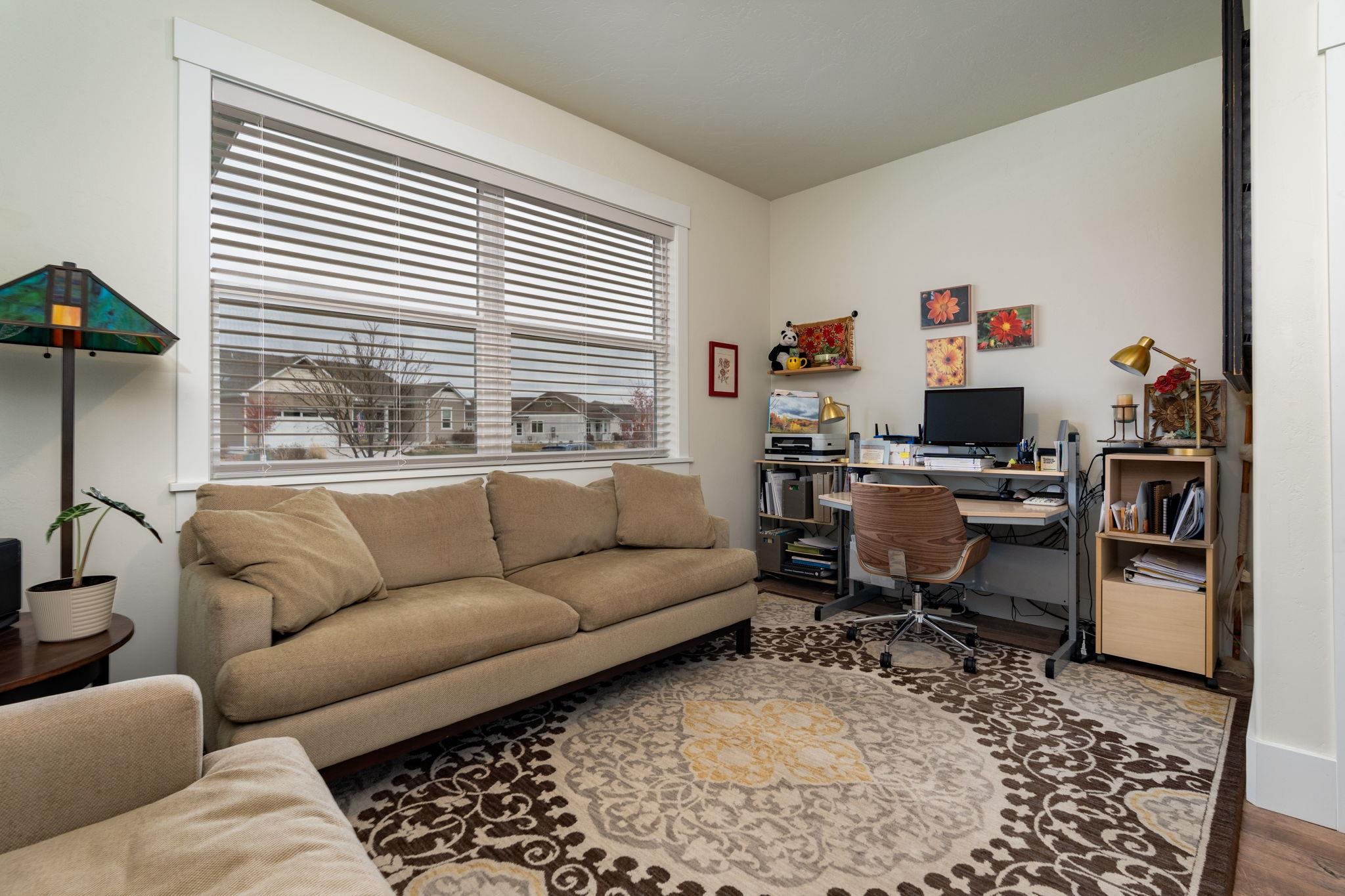 1222 Periwinkle Lane Fruita, CO 81521 - Photo 24 of 27 a living room with furniture a couch and a window