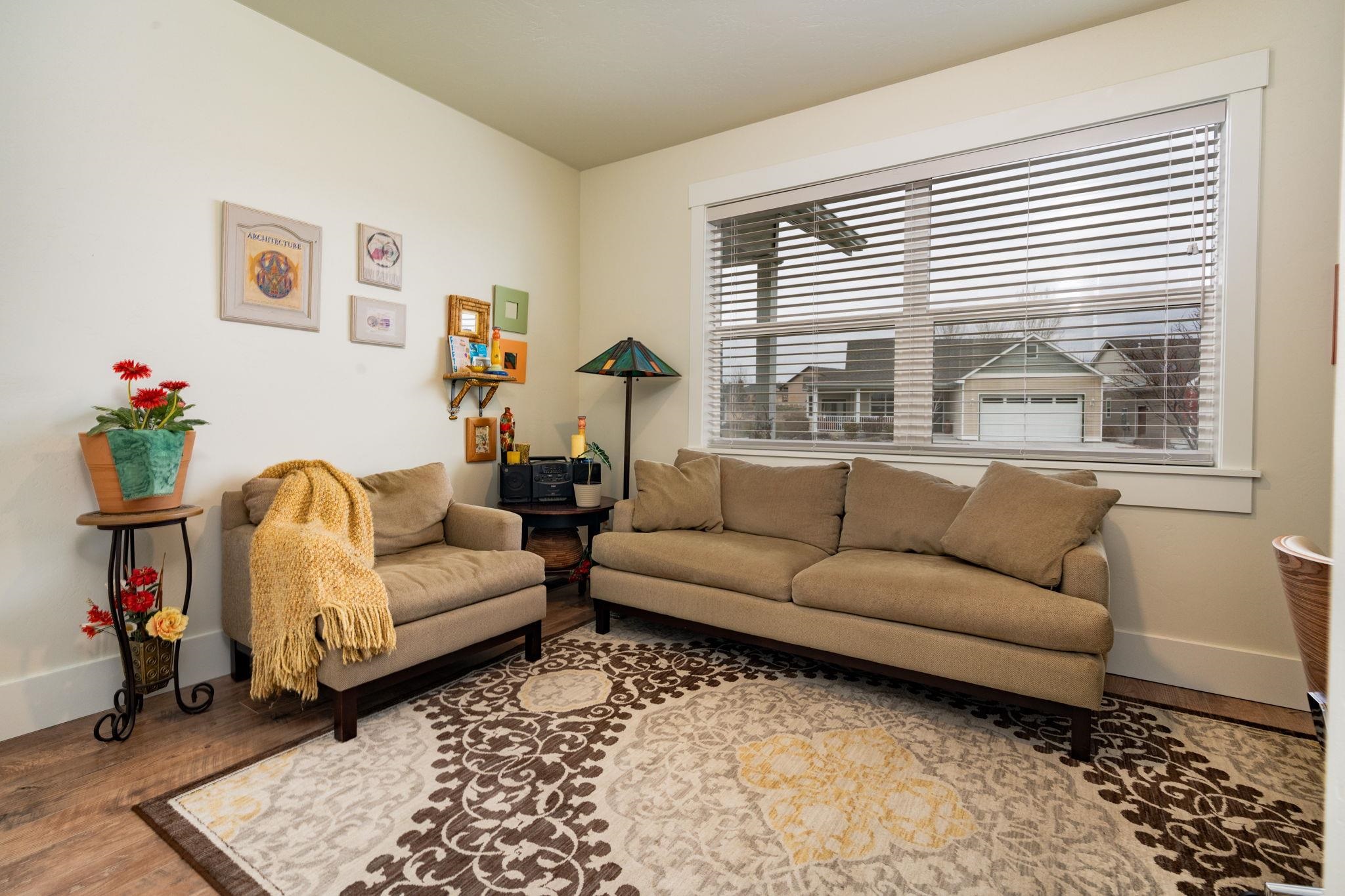 1222 Periwinkle Lane Fruita, CO 81521 - Photo 25 of 27 a living room with furniture and a window