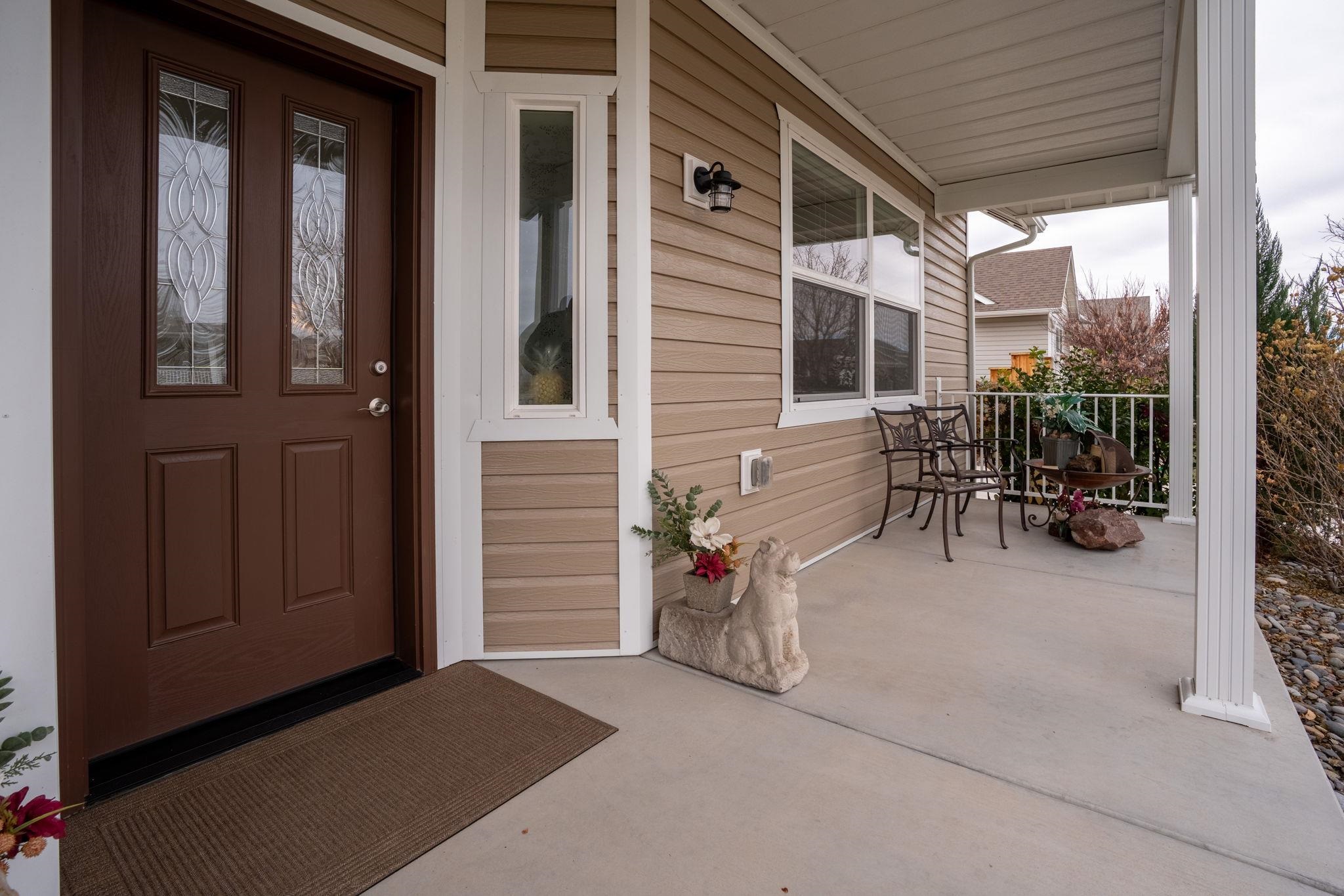 1222 Periwinkle Lane Fruita, CO 81521 - Photo 4 of 27 a backyard of a house with table and chairs