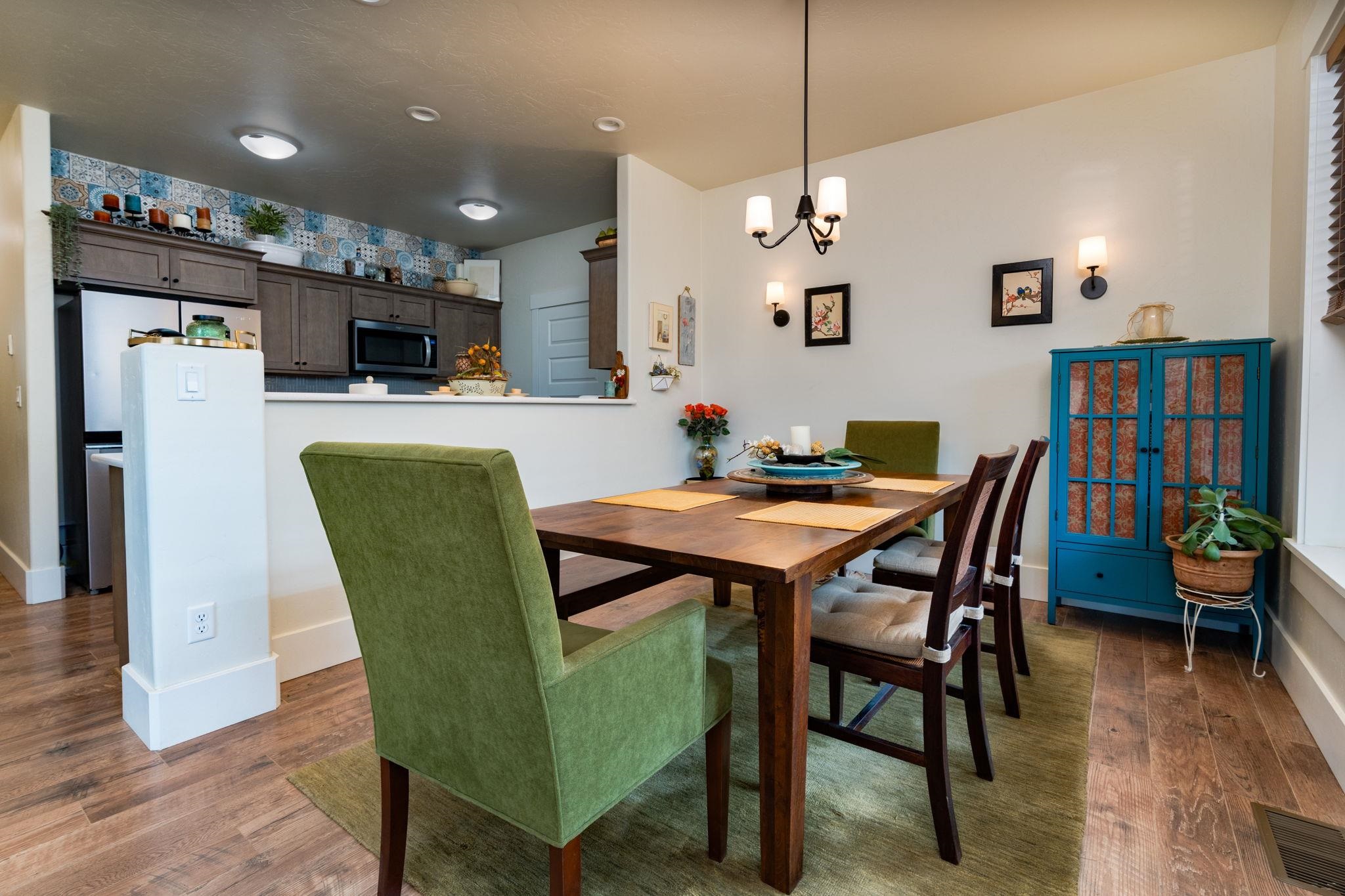 1222 Periwinkle Lane Fruita, CO 81521 - Photo 10 of 27 a view of a dining room with furniture and wooden floor