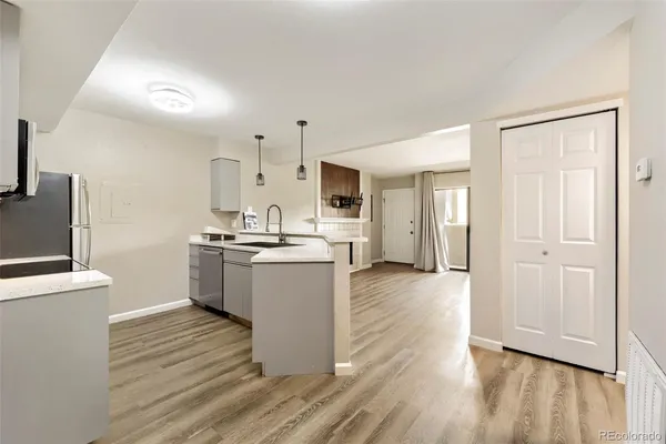 wooden floor fireplace and windows in an empty room
