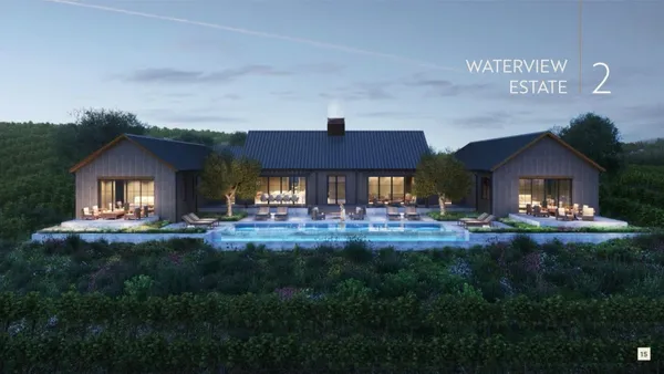 a front view of a house with yard and green space