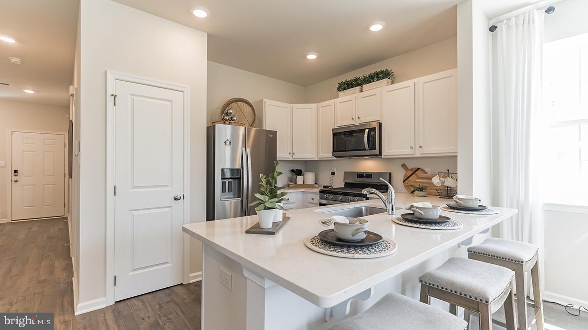 92 Arlotta Street Glassboro, NJ 08028 - Photo 6 of 25 a kitchen with sink refrigerator dining table and chairs