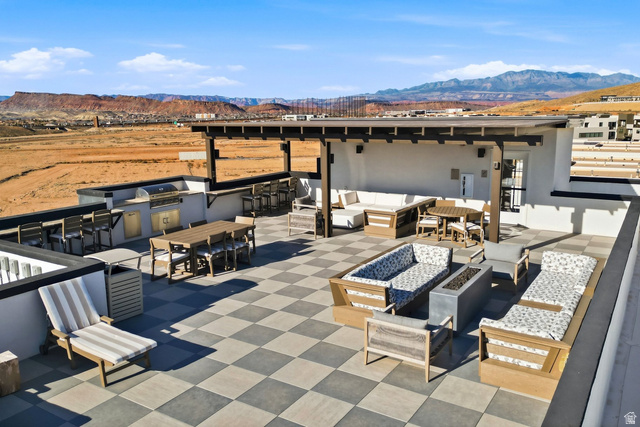 961 West Akoya Pearl Road, Unit 300 St. George, UT 84790 - Photo 47 of 60 View of patio featuring exterior kitchen, a mountain view, an outdoor bar and dining area, and an outdoor fire pit