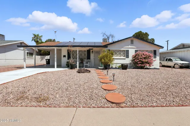 a front view of a house with a yard and sitting area