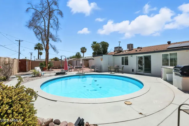 a view of a patio with a table and chairs
