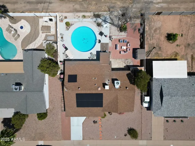an aerial view of a house with a swimming pool yard and mountain view in back