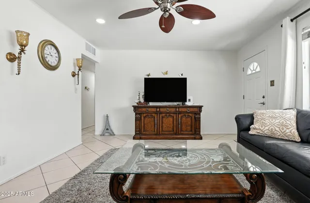 a living room with furniture a rug and white walls