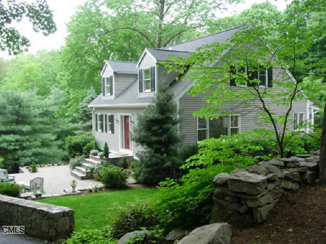 776 Ridgefield Road Wilton, CT 06897 - Photo 1 of 1 a front view of a house with a garden