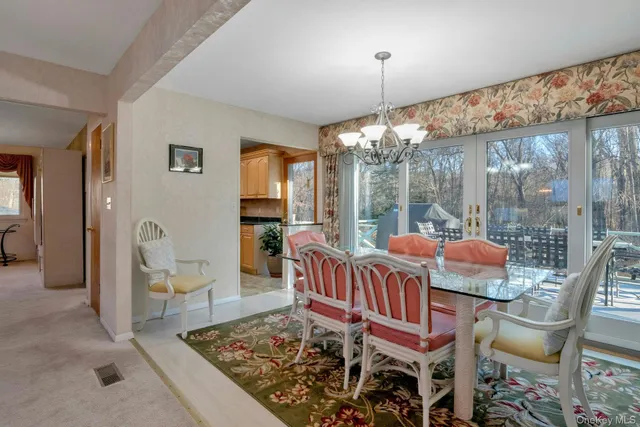 a view of a dining room with furniture wooden floor and chandelier
