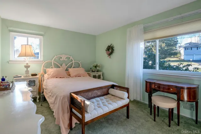 a bedroom with a bed table and window