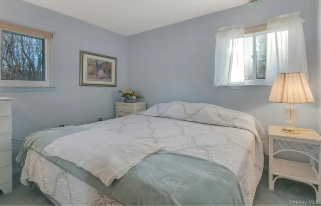 a bedroom with a bed and a lamp