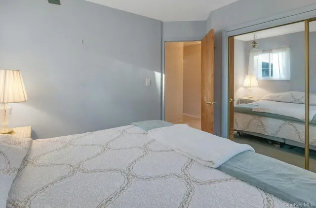 a bedroom with a bed and a mirror