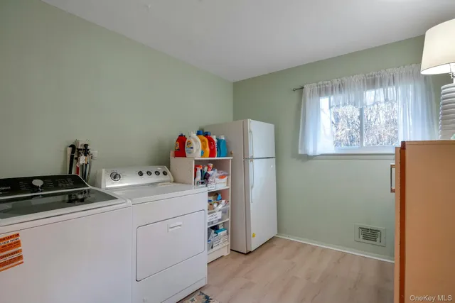 a utility room with closet dryer and washer
