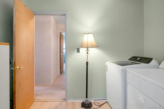 a view of a storage & utility room with a washer dryer