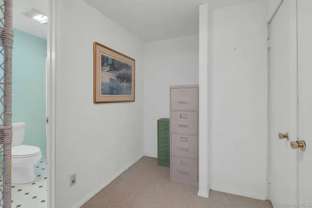 a view of a hallway with bathroom