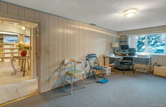 a view of a livingroom with furniture and a window