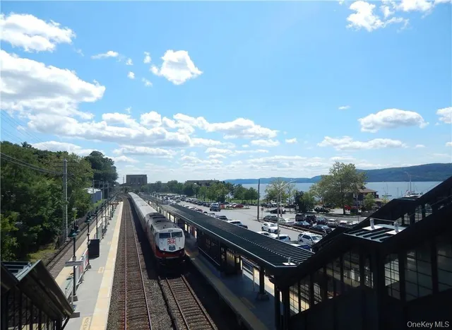 a view of a fountain in front of a house with a big yard