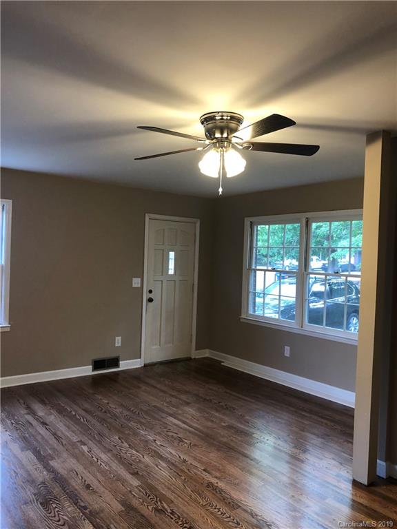 141 South Hillside Street Rutherfordton, NC 28139 - Photo 2 of 7 a view of an empty room with wooden floor and a window