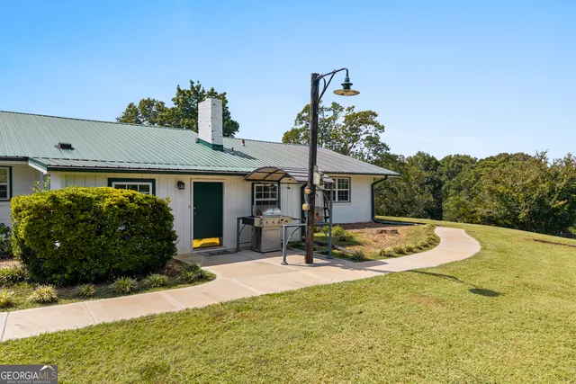 a living room with lots of furniture and view of kitchen