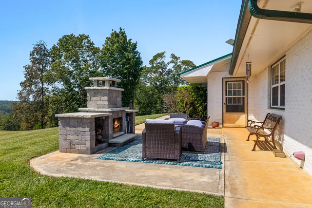 a living room with furniture a desk and chair with wooden floor