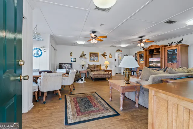 a utility room with stainless steel appliances a stove a refrigerator and a window