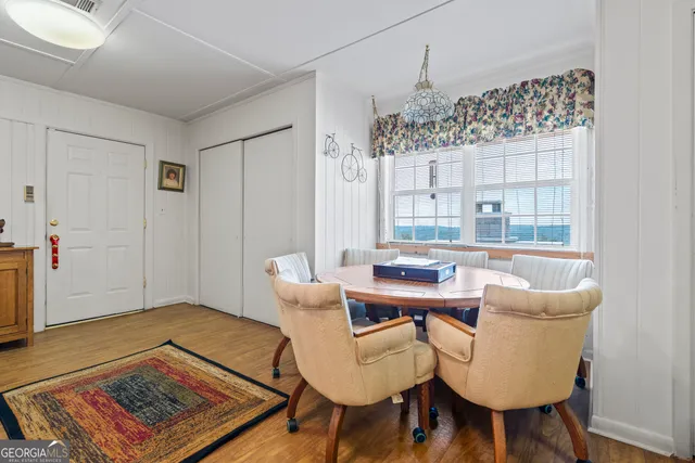 a kitchen with a stove a refrigerator and a dining table