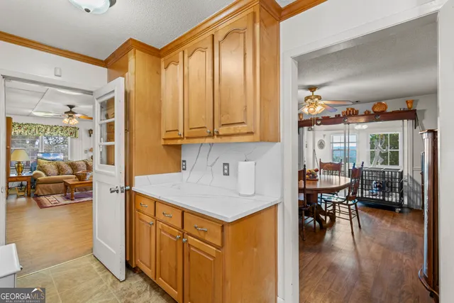 a view of a hallway with wooden floor and closet