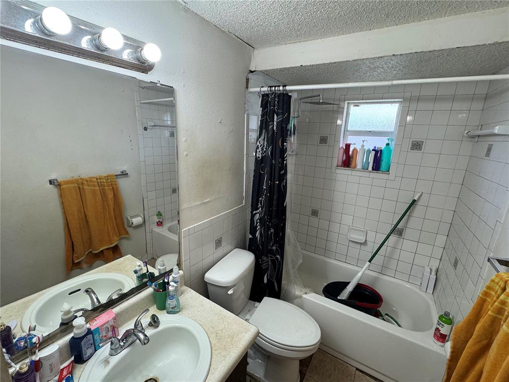 1004 Melrose Street Seffner, FL 33584 - Photo 12 of 40 a bathroom with a sink toilet and shower