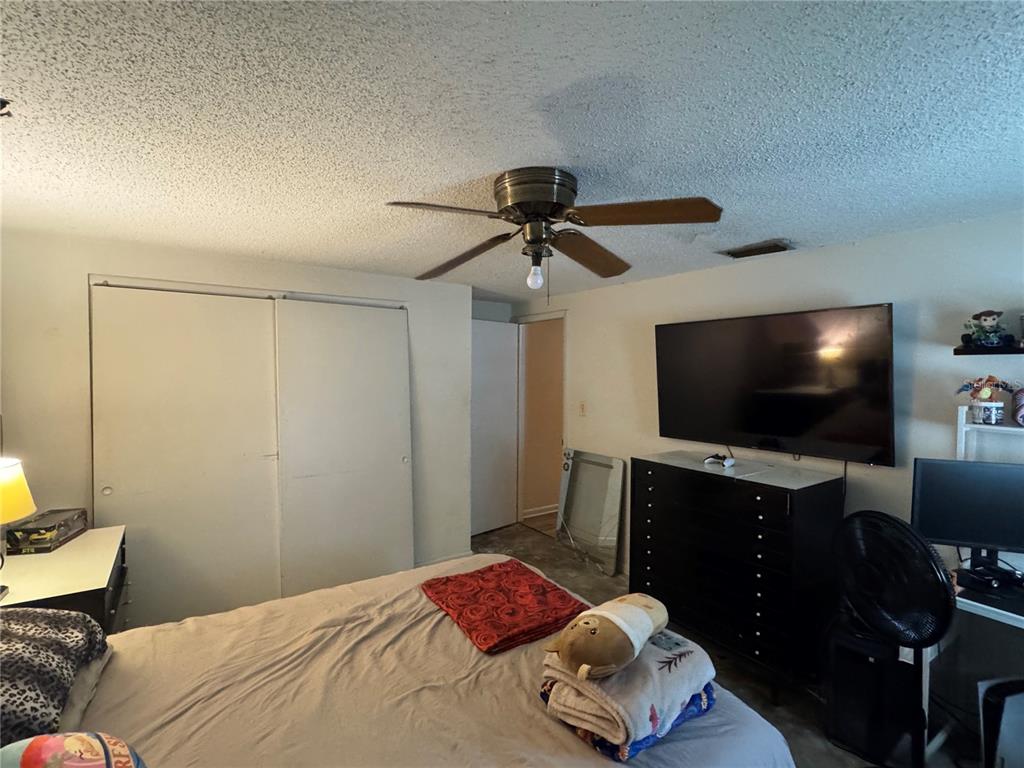 1004 Melrose Street Seffner, FL 33584 - Photo 18 of 40 a bedroom with a bed and a flat screen tv