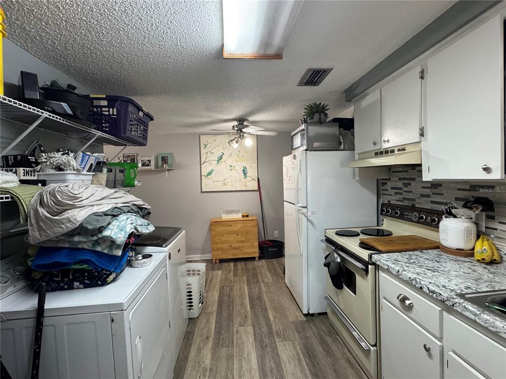1004 Melrose Street Seffner, FL 33584 - Photo 27 of 40 a kitchen with a stove and a refrigerator