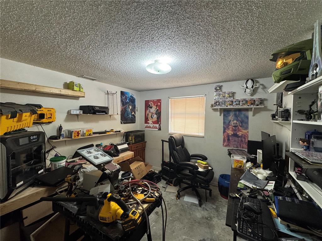 1004 Melrose Street Seffner, FL 33584 - Photo 34 of 40 a room with lots of furniture and clutter